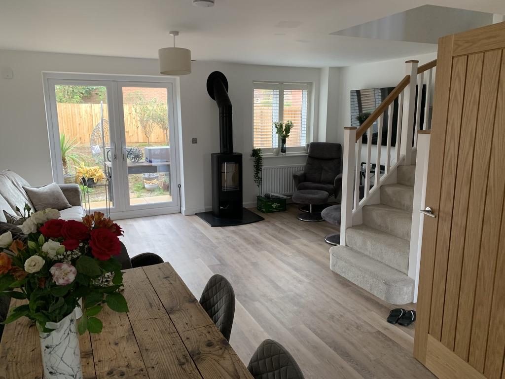 Open-plan living area with the new stove